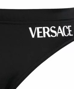 Versace repeated logo-print swimming trunks
